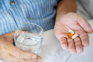 Person holds pills in their hand